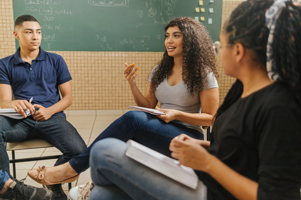 Estudiantes conversando en un salón de clases